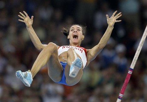 Russia's Yelena Isinbayeva clears the bar to break the world record as she wins gold in the women's pole vault final during the athletics competitions in the National Stadium at the Beijing 2008 Olympics in Beijing, Monday, Aug. 18, 2008.