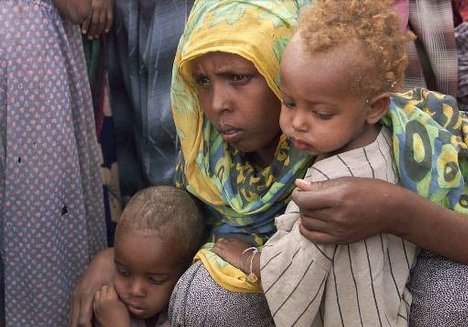 A mother waits with her malnourished children for evaluation by French Action Against Hunger (ACF) doctors in Dalaad, 400 kilometers (248 miles) southeast of Addis Ababa, Ethiopia Saturday April 15, 2000. The lives of millions of starving Ethiopians can be saved if international donors respond quickly to new requests for food aid, the U.N. special envoy to the Horn of Africa said Friday. 