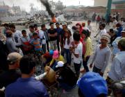 Cambodian garment workers prepare to defence from police attack during a strike