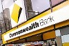 Pedestrians walk past a Commonwealth Bank of Australia branch