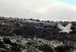 People look at the wreckage of Algerian military transport plane after it slammed into a mountain in the countryâ€™s rugged eastern region, Tuesday, Feb. 11, 2014