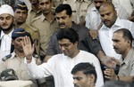 Founder of the hard-line Maharashtra Reconstruction Party Raj Thackeray, center, wearing white, walks out of the Bandra Court in Mumbai, India, Tuesday, Oct. 21, 2008