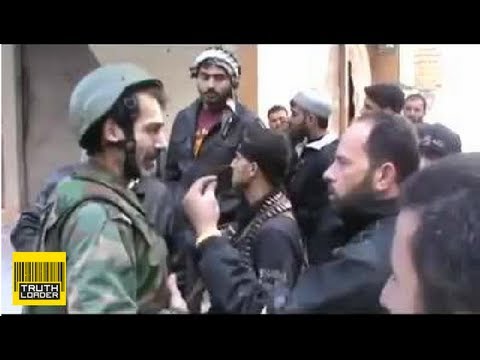 Syrian soldier Mustafa Shaddoud puts down rifle to talk to his FSA 