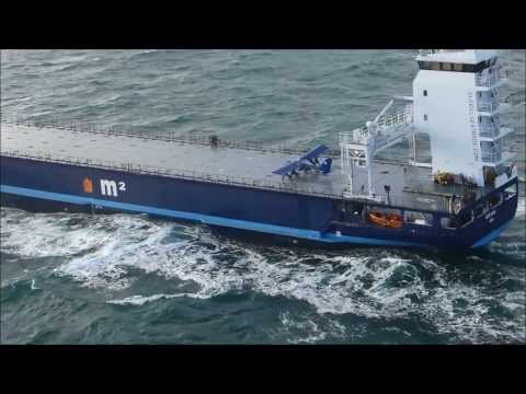 Extreme small plane landing on a ship at sea