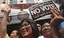 Anti-government supporters displays a "No vote" sticker and donation for the cause during a march through China Town in Bangkok Saturday, Feb. 1, 2014.