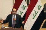 Iraq's Prime Minister Nouri al-Maliki speaks to the Iraqi lawmakers before submitting his new government for approval in Baghdad, Iraq, Tuesday, Dec. 21, 2010. Iraqi lawmakers unanimously approved on Tuesday a new government to be headed by incumbent Shiite Prime Minister Nouri al-Maliki, ending nine months of political deadlock that threatened to stall economic development and suck the country back into sectarian violence.