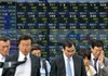 Passersby walk past a stock price board outside a securities company in Tokyo, Friday, June 27, 2008. Japanese stocks dropped for a seventh day to a two-month low on Friday as sentiment turned downbeat on an overnight tumble on Wall Street and skyrocketing global oil prices. The benchmark Nikkei 225 index lost 277.96 points, or 2.01 percent, to 13,544.36, the lowest finish since late April