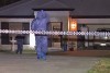 Police at house where a 23-year-old woman was stabbed to death at Logan, south of Brisbane, on February 16, 2014