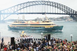 A Manly Ferry passes the Ashes reception at the Sydney Opera House.