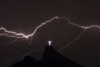 Lightning flashes over the Christ the Redeemer statue on top of Mount Corcovado in Rio de Janeiro.