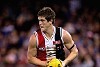 Nick Dal Santo runs with the ball during a game for Saint Kilda