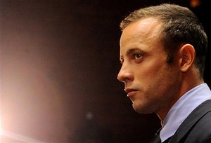 FILE - In this photo taken Friday, Feb. 22, 2013 Olympic athlete, Oscar Pistorius, in court in Pretoria, South Africa, for his bail hearing charged with the shooting death of his girlfriend, Reeva Steenkamp. Even if Pistorius is acquitted of murder, firearms and legal experts in South Africa believe that, by his own account, the star violated basic gun-handling regulations by shooting into a closed door without knowing who was behind it, exposing himself to the lesser but still serious charge of culpable homicide.