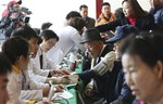 Elderly people receive medical check as they arrive for a hotel to take part in the reunions with their family members in North Korea, in Sokcho, South Korea, Wednesday, Feb. 19, 2014.