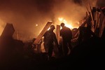 Anti-government protesters are silhouetted against the flame during a clash with riot police in Kiev's Independence Square, the epicenter of the country's current unrest, Ukraine, Thursday, Feb. 20, 2014.