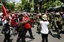 Protesters who support ousted Prime Minister Thaksin Shinawatra cheer at a group of soldiers after forcing them to retreat from a street during an anti-government demonstration Tuesday, April 6, 2010 in Bangkok, Thailand. Thousands of anti-government demonstrators clashed with Thai police and military troops trying to prevent them from leaving from the capital's commercial district Tuesday to stage protests elsewhere in Bangkok.