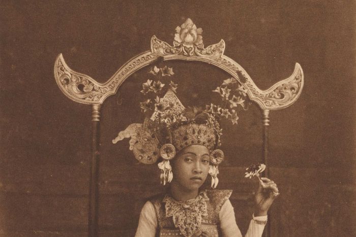 A dancing-girl of Bali, resting, c.1925. Photogravure.