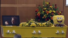 Yellow casket in the chapel at funeral of Luke Batty