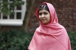 Malala Yousafzai listens as Harvard President Drew Gilpin Faust, not pictured, introduces her to reporters at Harvard University Friday, Sept. 27, 2013, on the school's campus in Cambridge, Mass. The Pakistani teenager, an advocate for education for girls, survived a Taliban assassination attempt last year on her way home from school.