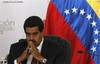 Venezuela's interim President Nicolas Maduro sits as he waits for the official ceremony at the Electoral Council to certify his victory on Sunday's presidential election in Caracas, Venezuela, Monday, April 15, 2013.