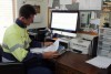 Farmer Paul Carmody sits at his computer