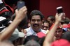 Venezuela's interim President Nicolas Maduro smiles as he's surrounded by supporters during a campaign rally in Sabaneta, Barinas state, Venezuela, Tuesday, April 2, 2013. Late President Hugo Chavez's chosen successor, Nicolas Maduro is competing against opposition leader Henrique Capriles in the April 14 presidential election.