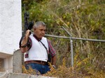 Retired Venezuelan Army Gen. Angel Vivas, armed and wearing a flak jacket, stands on his property in Caracas, Venezuela, Sunday, Feb. 23, 2014. President Nicolas Maduro ordered on Saturday the arrest and investigation of the retired general for his statements on YouTube and Twitter. Maduro said Vivas is instigating violence at a time when two weeks of anti-government protests have left 10 dead and over 100 wounded. Vivas became an opponent of the Venezuelan government since his 2007 resignation as director of the Ministry of Defense Engineering for his opposition to the military's adoption of the slogan "Fatherland, socialism or death, we shall overcome", created in Cuba.