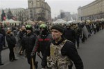 Anti-Yanukovych protesters march in Kiev's Independence Square, the epicenter of the country's current unrest, Ukraine, Tuesday, Feb. 25, 2014.