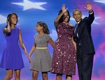 President Barack Obama and First lady Michelle Obama waves to delegates as their daughters Malia and Sasha join them at the Democratic National Convention in Charlotte, N.C., on Thursday, Sept. 6, 2012.