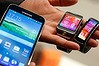 The new Samsung Galaxy S5 smartphone, left, with the Gear 2 smartwatch, centre, and Gear Fit fitness band. Samsung has added biometrics to its new flagship device.