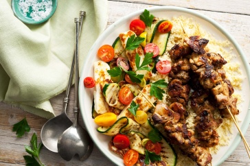 Harissa chicken skewers on zucchini ribbon and haloumi salad