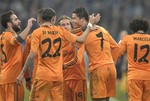 Real's Cristiano Ronaldo, centre right celebrates with team mates after scoring during a Champions League round of sixteen