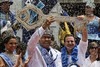 A crowned and costumed Wilson Dias da Costa Neto, center, the 2014 King Momo or Carnival King, holds up the key of the city with Rio de Janeiro's Mayor Eduardo Paes at a ceremony marking the official start of Carnival, in Rio de Janeiro, Brazil, Friday, Feb. 28, 2014.