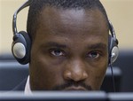  Germain Katanga looks up from his screen as he waits for the start of Katanga&acute;s trial at the International Criminal Court in The Hague, Netherlands, Monday Oct. 22, 2007. Katanga is accused of committing war crimes in the Democratic Republic of Con