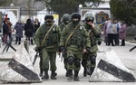 Pro Russian soldiers guard Ukraine's infantry base in Perevalne, Ukraine, Tuesday, March 4, 2014.