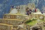 Tourists visit the ruins of Machu Picchu near Cusco, Peru, Friday Sept. 12, 1997, after the site was closed for one week because of encroaching forest fires. The mountain in the background, Huayna Picchu, was burned and blackened by the fires. Rain extinguished most of the fires Wednesday before they could harm the ancient Incan city. (AP Photo/Ricardo Choy Kifox)