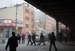 Police move people away from the scene of an explosion and building collapse in the East Harlem neighborhood of New York, Wednesday, March 12, 2014