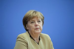 German Chancellor Angela Merkel listens during a press conference in Berlin, Germany, Monday, Sept. 17, 2012.