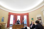 File - President Barack Obama talks on the phone with President Vladimir Putin of Russia in the Oval Office, March 1, 2013.