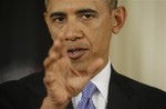 President Barack Obama gestures as he answers a question during a joint news conference with Afghan President Hamid Karzai in the East Room of the White House in Washington