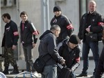 Members of the Crimean self defense forces check a passenger at the main railway station in Simferopol, Ukraine, Friday, March 14, 2014, ahead of the March 16 referendum that will ask residents if they want the territory to become part of Russia.