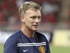 Manchester United's manager David Moyes walks on the pitch before his team match against Thailand's Singha All Star at Rajamangala national stadium in Bangkok, Thailand Sazturday, July 13, 2013. Manchester United lost to Thailand's Singha All Star 0-1 the first match under Moyes' management after he took up position early this month.