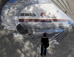 A student from the Benigno "Ninoy" Aquino High School looks at a mural depicting the missing Malaysia Airlines plane Tuesday, March 18, 2014 at their campus at Makati city, east of Manila, Philippines. Officials revealed a new timeline Monday suggesting the final voice transmission from the cockpit of the missing Malaysian plane may have occurred before any of its communications systems were disabled, adding more uncertainty about who aboard might have been to blame.