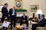 File - President Barack Obama and Vice President Joe Biden meet with Gen. Martin Dempsey, Chairman of the Joint Chiefs of Staff, and Defense Secretary Leon Panetta in the Oval Office, Feb. 28, 2012.