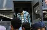 One of four men convicted of gang raping a photojournalist in India's financial capital of Mumbai last year exits a police van as he is brought to prison, in Mumbai, India, Thursday, March 20, 2013.