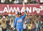 India's captain Virender Sehwag celebrates scoring a century during their fourth one day international cricket match against West Indies in Indore, India, Thursday, Dec. 8, 2011.