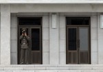 File - A North Korean soldier stands watch on the North Korean side of the Demilitarized Zone as U.S. Sailors assigned to the Ronald Reagan Carrier Strike Group tour the DMZ in Panmunjom, South Korea, July 17, 2008.