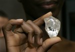 A model holds the 'Letseng Legacy' diamond is shown at the World Diamond Center in Antwerp, Belgium, Wednesday, Nov. 14, 2007. The 493 carat diamond, the 18th largest in the world, was recovered from the Letseng Le Terai mine in Lesotho on Sept. 7, 2007. (AP Photo/Virginia Mayo)hg3