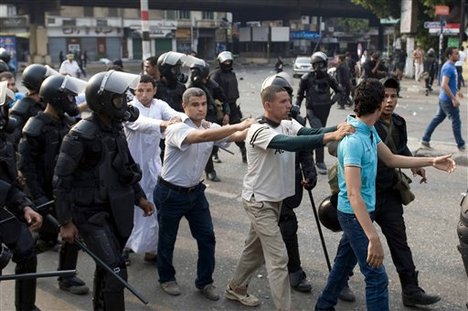 In this Sunday, Oct. 6, 2013 file photo, supporters of Egypt's ousted President Mohammed Morsi are detained during clashes with riot police in Cairo, Egypt.