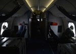 Naval aircrewmen assigned to Patrol Squadron (VP) 16 look for floating debris while on a P-8A Poseidon during a mission to assist in search and rescue operations for Malaysia Airlines flight MH370, 24 March, 2014.