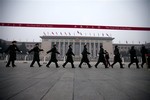 Chinese soldiers march outside the Great Hall of the People before the closing ceremony of the National People's Congress in Beijing, China, Sunday, March 17, 2013.